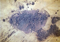 Satellite image of Bayuda volcanic field in Sudan where nepheline-rich trachybasalt lavas have been erupted during the Holocene epoch[1]