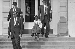 Due to threats and violence against her, U.S. Marshals escorted 6-year-old Ruby Bridges to and from the previously whites only William Frantz Elementary School in New Orleans, 1960. As soon as Bridges entered the school, white parents pulled their children out.