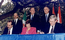 From left to right: (standing) President Carlos Salinas, President Bush, Prime Minister Brian Mulroney; (seated) Jaime Serra Puche, Carla Hills, and Michael Wilson at the NAFTA Initialing Ceremony, October 1992