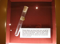 A glass vial in a museum display case