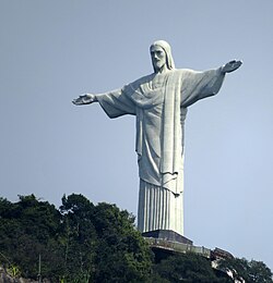 Christ the Redeemer statue in Rio de Janeiro, Brazil. The monument is made of reinforced concrete clad in a mosaic of thousands of triangular soapstone tiles.[128]