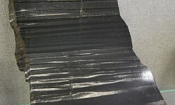 Exsolution lamellae (alternating bands) of orthopyroxene and clinopyroxene in a specimen of pyroxene from Quebec, Canada