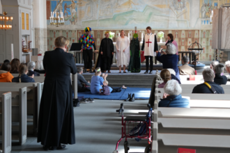 During an Evangelical-Lutheran Mass on Saint George's Day, children reenact the heroism of Saint George at Saint George's Evangelical-Lutheran Church in Stockholm, part of the Church of Sweden.