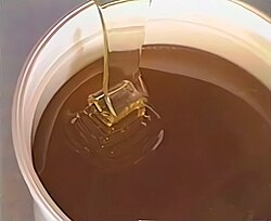The high viscosity of honey results in perfectly laminar flow when poured from a bucket, while the low surface tension allows it to remain sheet-like even after reaching the fluid below. Analogous to turbulence, when the flow meets resistance it slows and begins oscillating back and forth, piling upon itself.