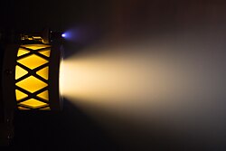 Ion thruster operating on iodine (yellow) using a xenon (blue) hollow cathode. High-energy ions emitted from plasma thrusters sputter material off the surrounding test chamber, causing problems for ground testing of high-power thrusters.[1]