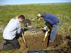 Excavating ice-rich permafrost with a jackhammer in Alaska.