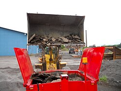 Chunks of Reclaimed Asphalt Pavement (RAP) are deposited for recycling.