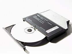 A CD-ROM in the tray of a partially open CD-ROM drive.