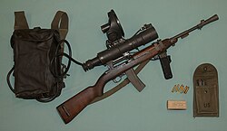 USMC M3 Sniperscope assembled on a M3 Carbine. Introduced during the Korean War, it was an early active infrared night vision equipment powered by a large 12 volt battery that was carried in a rubberized canvas backpack.