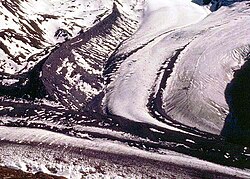 A glacier joining the Gorner Glacier, Zermatt, Switzerland. These glaciers transport sediment and leave behind lateral moraines.