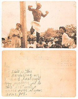 The front and back of a postcard showing the charred corpse of Will Stanley in Temple, Texas, in 1915. Joe Meyers marked the back of the postcard to show his parents he was in the crowd: "This is the Barbecue we had last night.. my picture is to the left with a cross over it.. your son Joe".[96]