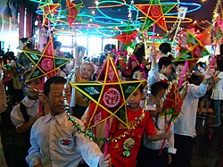 Vietnamese children celebrating the Tết Trung Thu with traditional 5-pointed star-shaped lantern