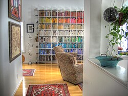 Household bookshelf arranged by color
