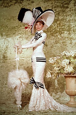 A publicity still of Hepburn wearing a costume designed by Cecil Beaton for the film