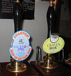 Cask ale hand pumps with pump clips detailing the beers and their breweries
