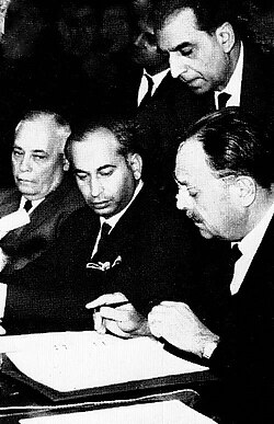 Signing of the Tashkent Declaration to end hostilities with India in 1965 in Tashkent, USSR, by President Ayub alongside Bhutto (centre) and Aziz Ahmed (left)[125]
