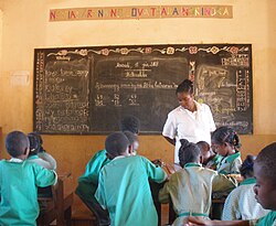 Teacher in a classroom in Madagascar (c. 2008). Primary and secondary school teaching is often considered a feminine occupation.