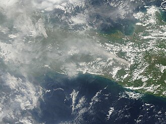 The Moderate Resolution Imaging Spectroradiometer (MODIS) on NASA's Terra satellite captured this image of the Merapi ash plume heading west on 10 November 2010. The dark brown streak down the southern face of the volcano is ash and other volcanic material deposited by a pyroclastic flow or lahar.