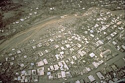 Aerial view of lahar damage and damage to roofs from tephra fall in Sapangbato, along Abacon River, south of Clark Air Base, June 22, 1991.
