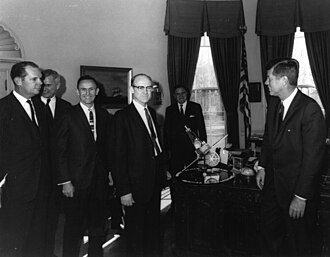 Dr. William H. Pickering, (center) JPL Director, presents a Mariner 2 spacecraft model to President John F. Kennedy in 1963. NASA Administrator James Webb is standing directly behind the Mariner model.