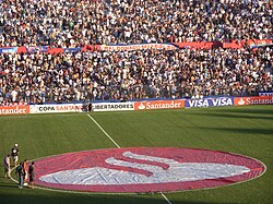 The logo of Banco Santander displayed on the field of Estadio Gran Parque Central, 2010