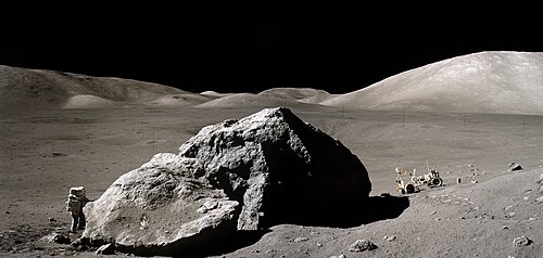 Composite image of Harrison Schmitt working next to Tracy's Rock during EVA-3