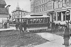 Seattle's first streetcar at the corner of Occidental and Yesler in 1884; all buildings depicted were destroyed by the Great Seattle Fire five years later, in 1889.