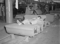Young striker off sentry duty sleeping on assembly line of auto seats