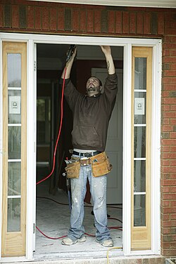 A person making repairs to a house after a flood