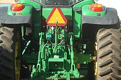 A PTO (in the box at the bottom) in the center of the three-point hitch of a tractor