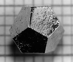 The material holmium–magnesium–zinc (Ho–Mg–Zn) forms quasicrystals, which can take on the macroscopic shape of a pentagonal dodecahedron. Only quasicrystals can take this 5-fold symmetry. The edges are 2 mm long.