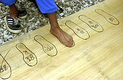 A soldier recruit measuring for shoe size during uniform issue at the Afghan National Army training site in Kabul, Afghanistan, 2002