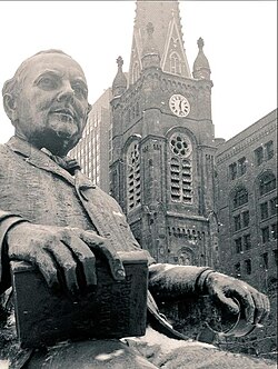 Statue of Tom Johnson holding Henry George's Progress and Poverty