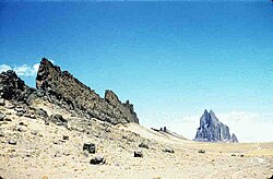 Shiprock, New Mexico, United States: a volcanic neck in the distance, with a radiating dike on its south side