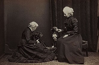 Photograph of an older Elizabeth Blackwell with her adopted daughter Kitty and two dogs, 1905