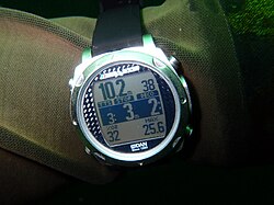 iDive DAN personal dive computer display showing decompression requirement and other data during a dive The central band shows time to surface from current depth, stop depth and stop time.
