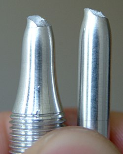 Tensile test of an Al-Mg-Si alloy. The local necking and the cup and cone fracture surfaces are typical for ductile metals.