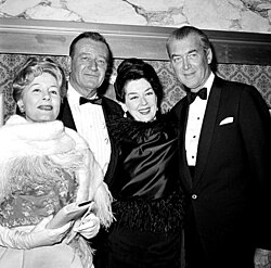 Irene Dunne, Wayne, Rosalind Russell and James Stewart at the premiere of How the West Was Won, 1962