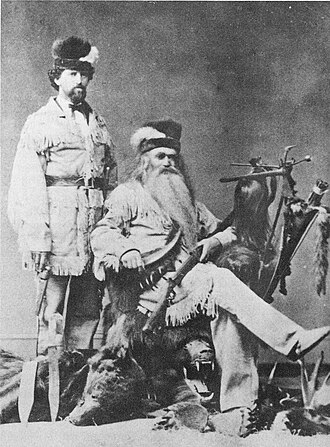 Seth Kinman (seated) with his son Carlin, displaying a few curiosities in 1876
