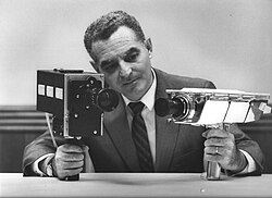 Stan Lebar, the project manager for Westinghouse's Apollo television cameras, shows the field-sequential color camera on the left and the monochrome lunar surface camera on the right.
