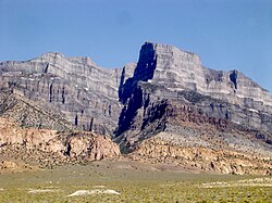 A Jurassic pluton of pink monzonite intruded below a section of gray sedimentary rocks which was subsequently uplifted and exposed, near Notch Peak, House Range, Utah.
