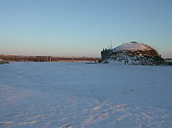 Snow scene of a modern reconstructed earth lodge at the Knife River Indian Villages National Historic Site, North Dakota