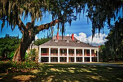 The white-columned plantation house, an "icon" of American architecture,[5] was the "popular embodiment of the plantation way of life" and the centerpiece of the very largest deep southern plantation complexes.[6] Pictured is Destrehan Plantation.