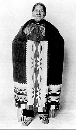 Susie Elkhair (Delaware Tribe of Indians, 1845–1925), wearing a ribbonwork shawl and Delaware dress with medallions in Oklahoma