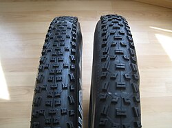 Mountain bicycle tires with an open-lug pattern for grip in soft soil