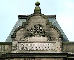 Pediment above entrance showing name of Mearns Street Public School in Greenock, Scotland, listed in 1881 for science instruction[26]