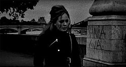 Adele walking alone in Paris in the black-and-white music video for "Someone like You"