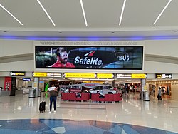 Main flight information board at the entrance to Concourse B