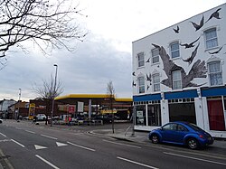 Petrol station at the site of 517 High Road, Leytonstone, where Hitchcock was born; commemorative mural at nos. 527–533 (right)[16]