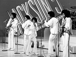 Jackson (center) as a member of the Jackson 5 in 1972. The group were among the first African American performers to attain a large following.[33]